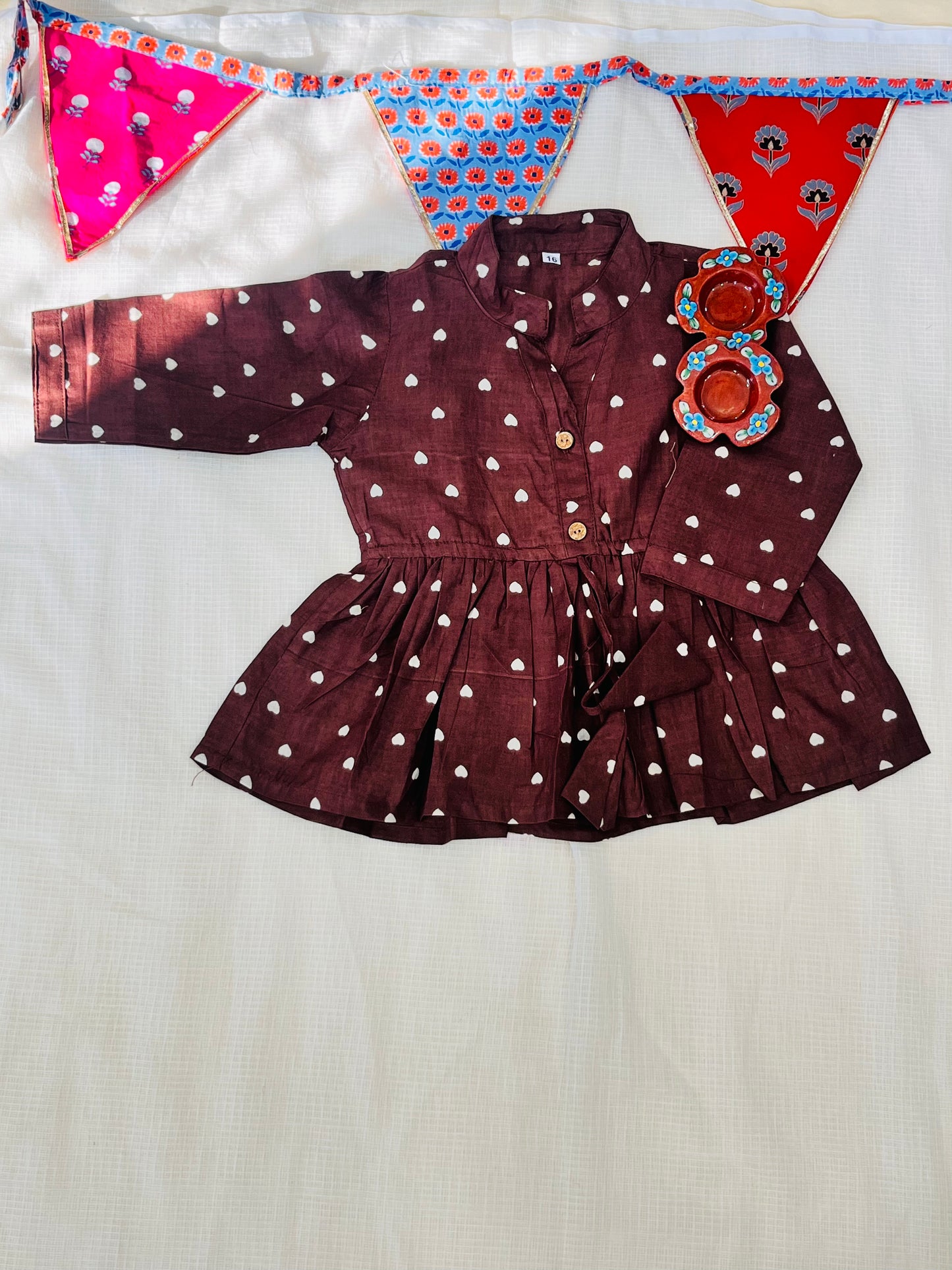 Gathered polka dot printed top with front button opening