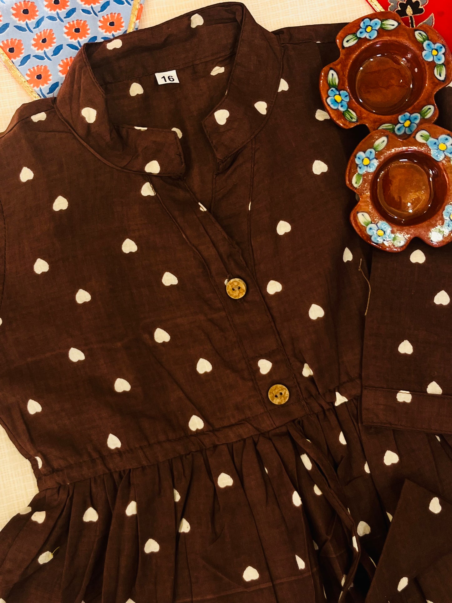 Gathered polka dot printed top with front button opening