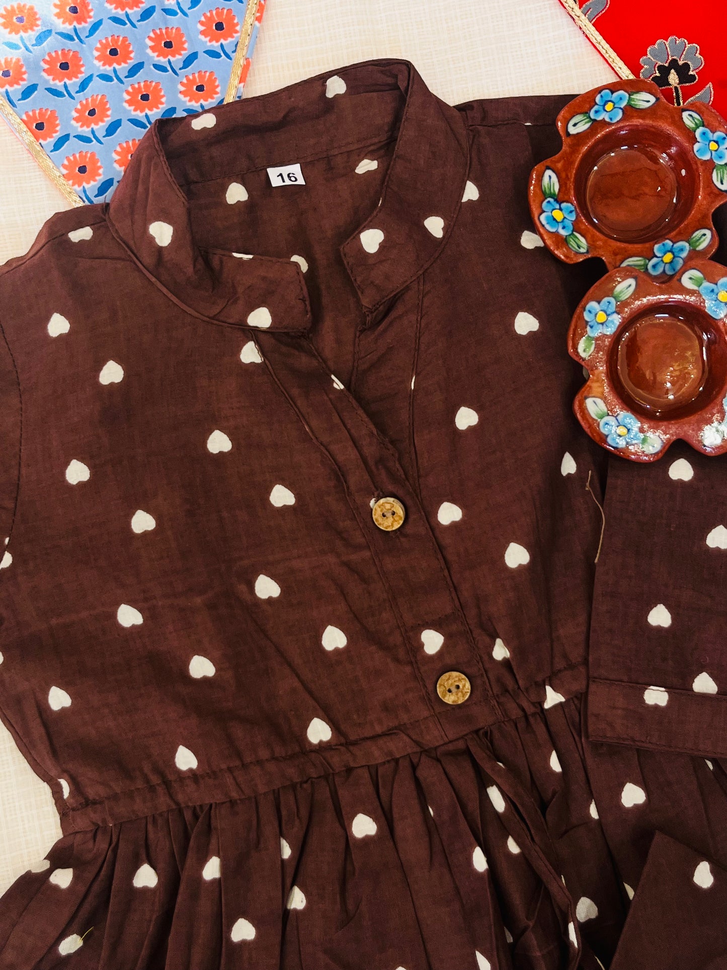 Gathered polka dot printed top with front button opening