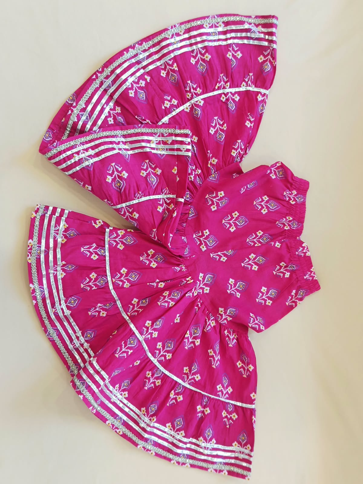 Patola printed, Pink colored flared kurti with sharara and dupatta